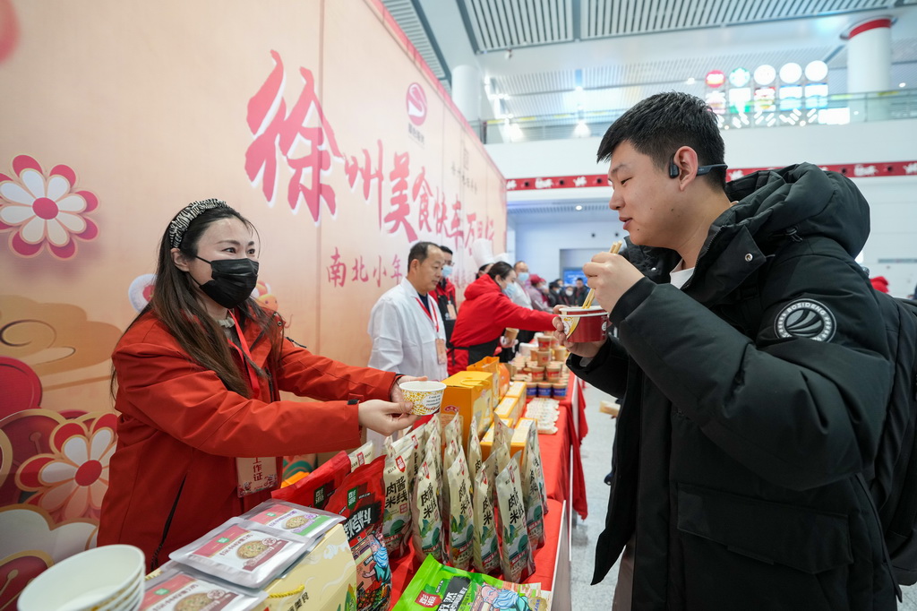 1月22日，旅客在高铁徐州东站候车大厅品尝徐州当地美食。