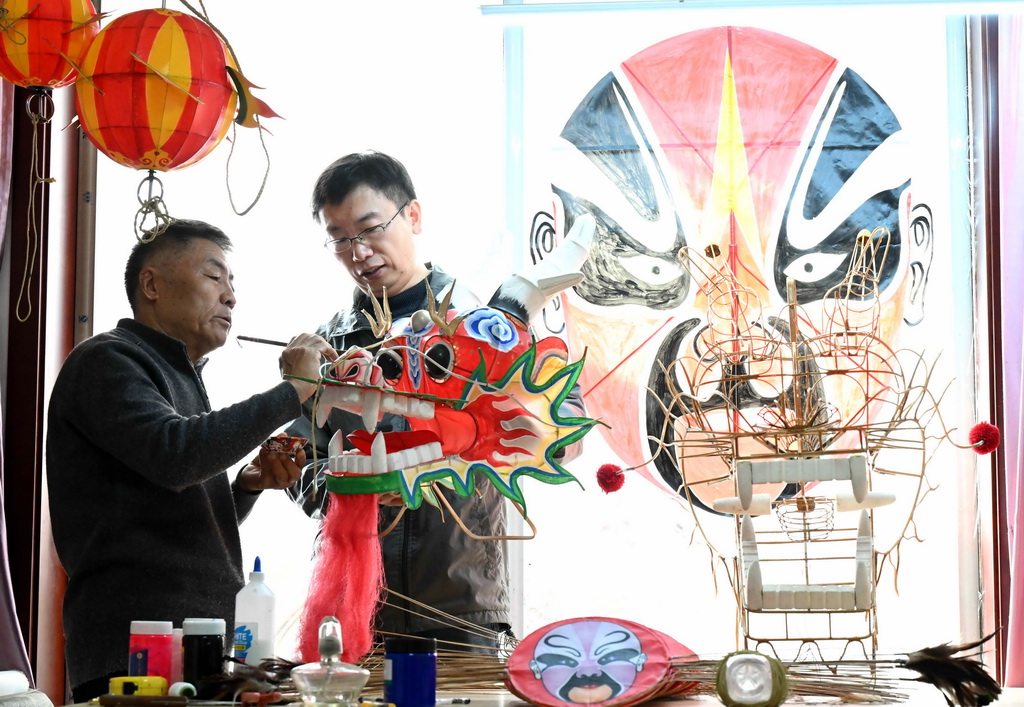 2月26日，王彦州（左）在石家庄市家中制作龙风筝。新华社发（陈其保摄）