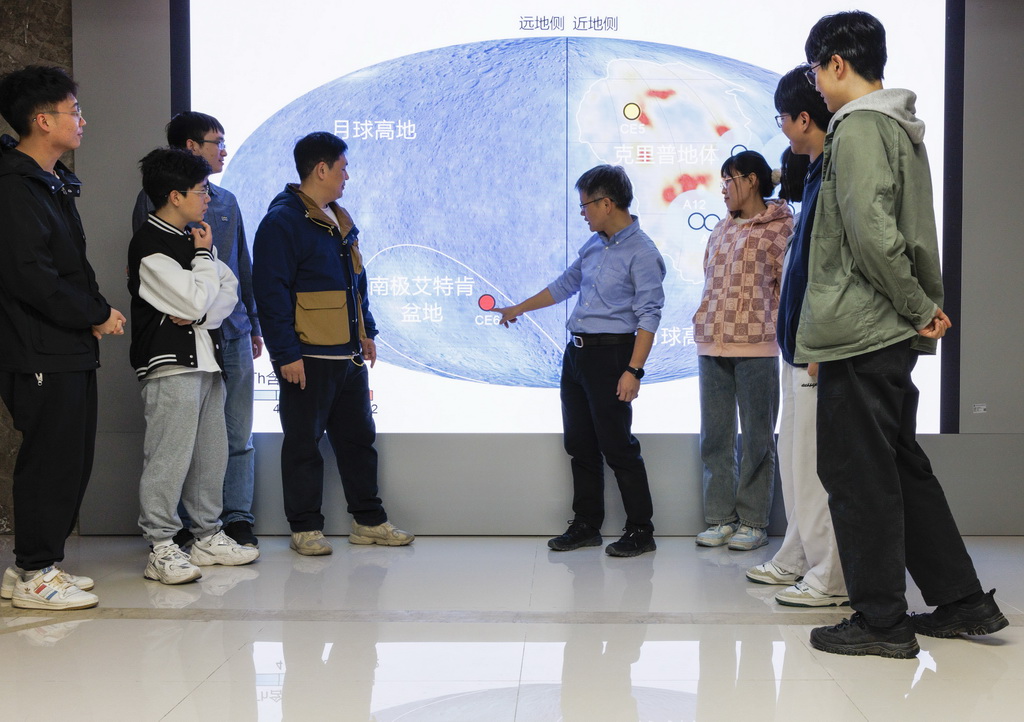 4月8日，在中国科学院地质与地球物理研究所，胡森研究员（左五）向团队成员解释研究成果。