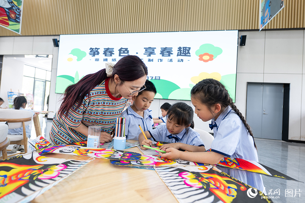 2025年4月17日，在浙江省嘉兴市余新镇长秦村，一群小朋友在老师的指导下，亲手制作纸鸢，体验非遗手工带来的乐趣。