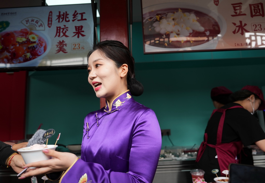 2024年5月10日，沈阳故宫博物院讲解员为游客介绍美食文创产品。新华社记者 李钢 摄