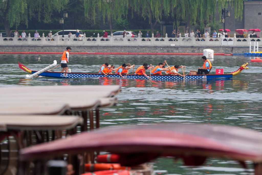 5月29日,2025中国大运河文化带京杭对话配套活动“河之端”龙舟赛在北京市西城区什刹海进行,中央民族大学国际龙舟队在比赛中。新华社记者 鞠焕宗 摄