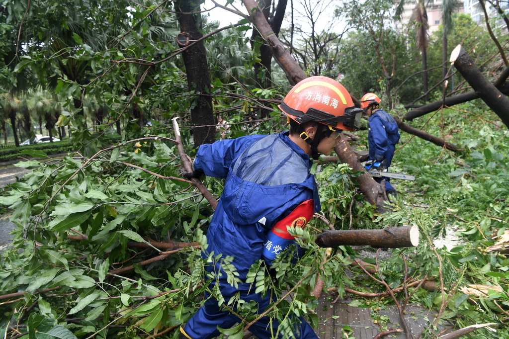 8月25日,在海南省三亚市凤凰路,三亚市消防救援支队救援人员进行清障作业。