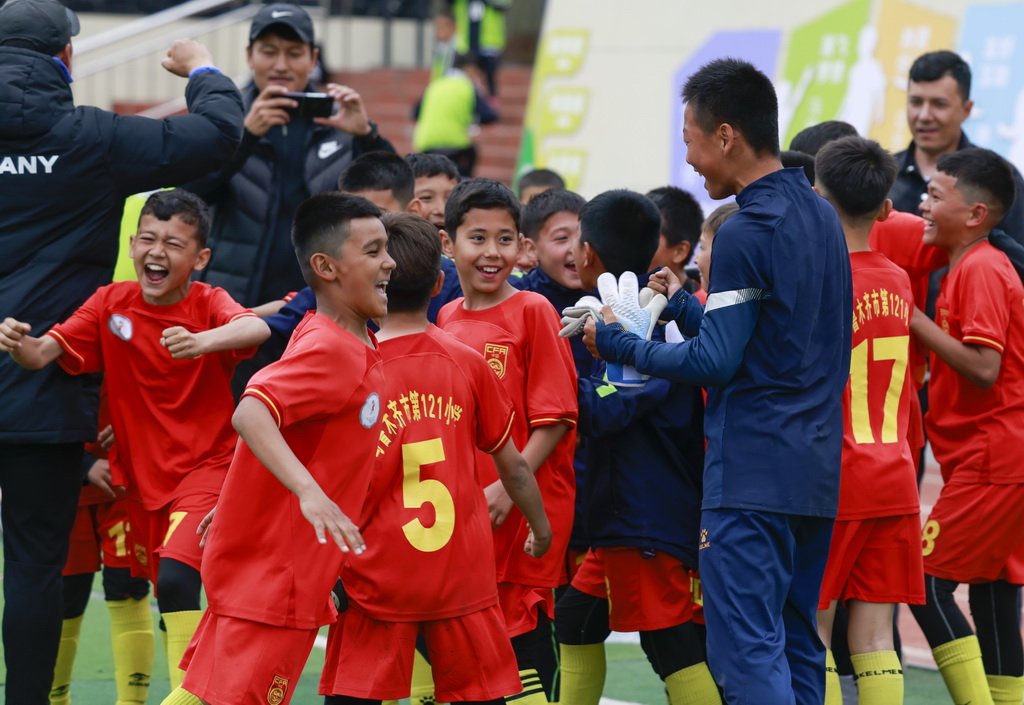 4月16日，在乌鲁木齐市水磨沟区第五届中小学足球联赛中，乌鲁木齐市第121小学足球队赢得比赛后庆祝。新华社记者 王菲 摄