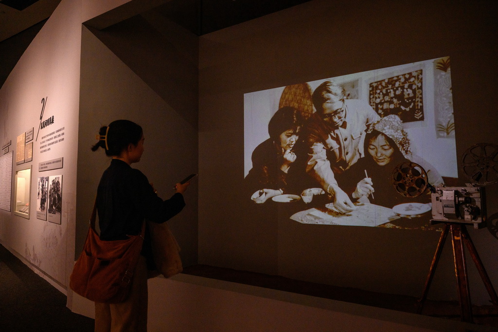 10月28日，观众观看画家指导农民绘画的老照片。