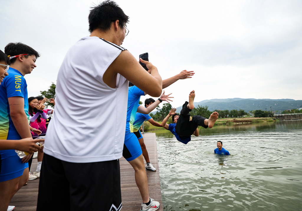11月1日,赛艇队成员在训练后为教练朱铭琨(右二)和学员赵煜阳(右一)庆祝生日。新华社记者 胡星宇 摄
