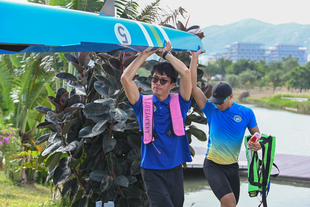11月1日,教练朱铭琨(左)在训练后帮助学员收纳赛艇。新华社记者 肖恩楠 摄