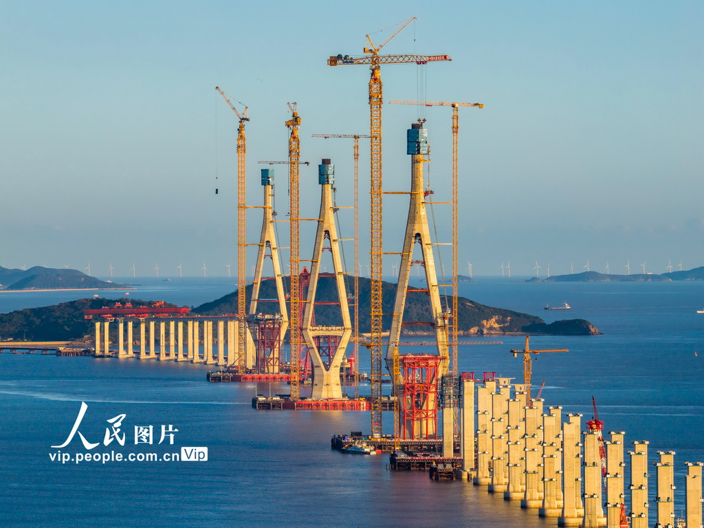 11月16日，宁波舟山港六横公路大桥二期工程，Q3主墩首片钢箱梁架设成功后的海中三主塔及其连线。