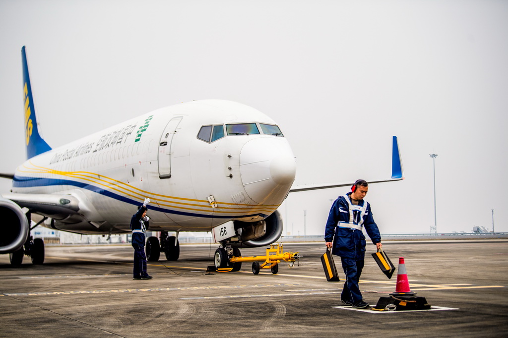 12月9日,工作人员进行中国邮政“重庆至仰光”国际货邮航线首航货机起飞前的准备工作。