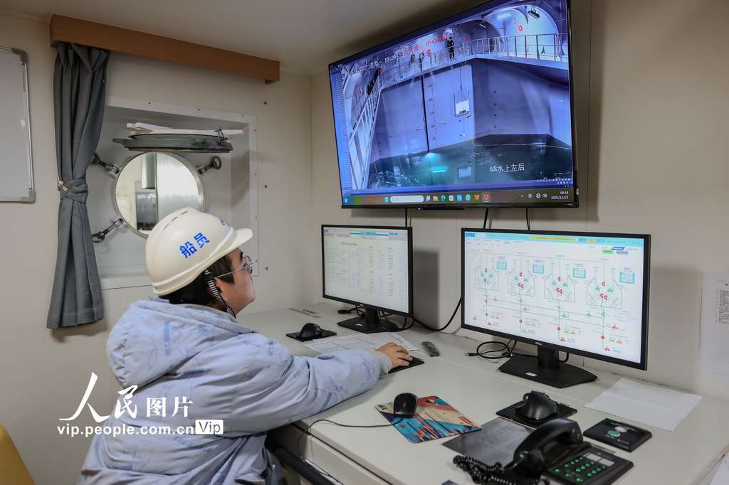 12月22日，“苏海1号”养殖工船上的工作人员在监控室查看三文鱼鱼苗投放情况。