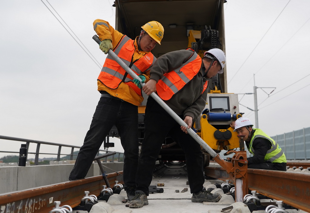 1月19日拍摄的昌九高铁庐山南站至共青城东站区段铺轨施工现场。