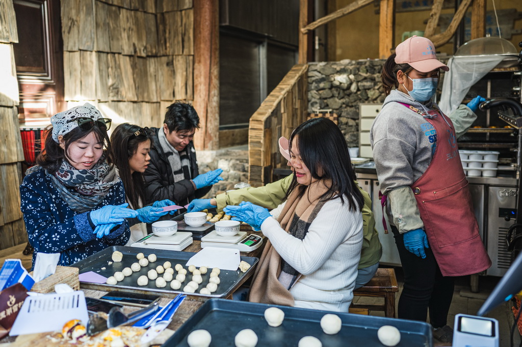 1月17日，游客在丽江市玉龙纳西族自治县白沙镇玉湖村体验制作鲜花饼。新华社记者 王冠森 摄