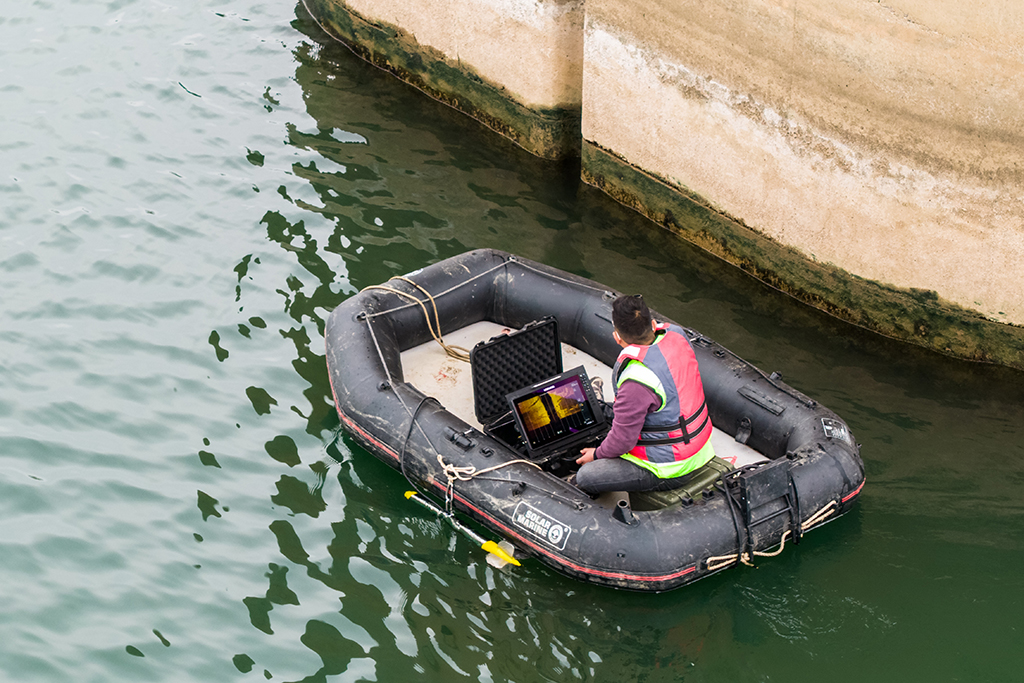 1月29日，在沪昆高铁湘江特大桥下，铁路工人在搭载声呐检测系统的汽艇上进行水下墩身成像作业（无人机照片）。