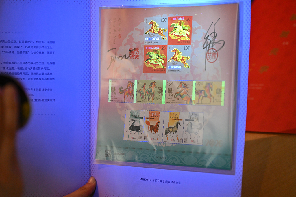 这是紫光灯照射下的《骏驰元宇》邮票珍藏册内邮票呈现的荧光油墨印制工艺效果（1月29日摄）。