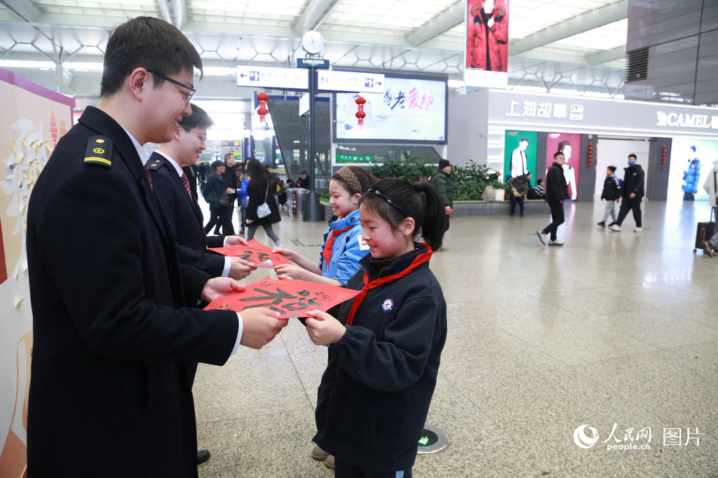 2月2日，春运首日，上海虹桥火车站两名小学生参加“新春送福”活动，写下两幅“福”字送给虹桥站的工作人员。人民网记者 龚莎摄