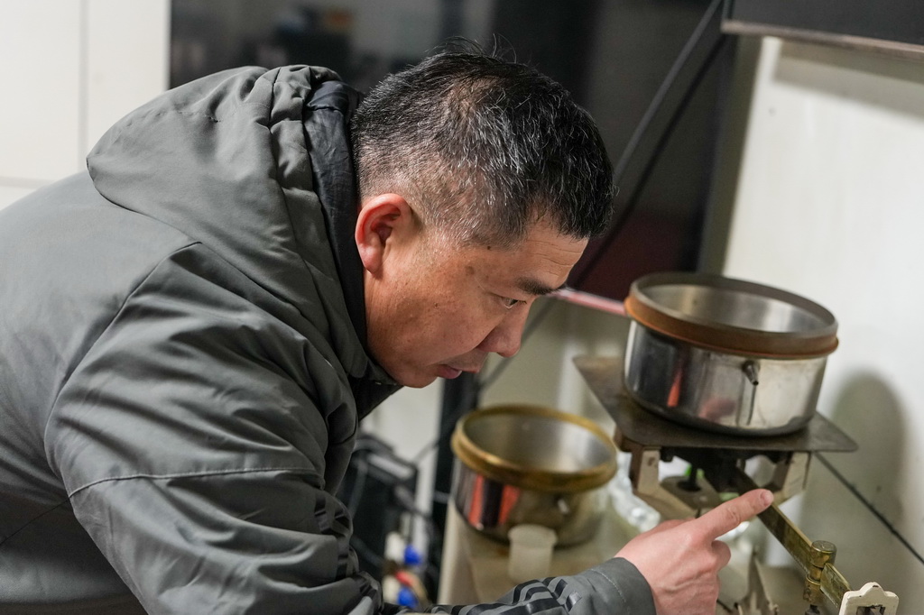 2月6日，观测员杨正民在称量蒸发量。