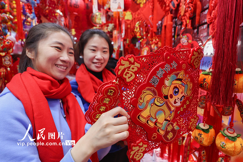 农历马年春节将至，北京各大商场的年货饰品琳琅满目，红灯笼、春联、福字及马年主题装饰汇集一堂，市民纷纷选购，点燃节前消费热潮。陈晓根摄（人民图片网）