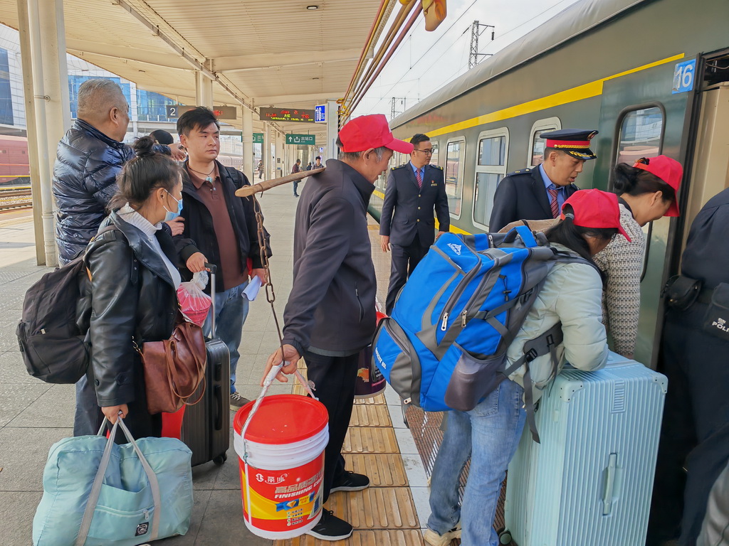 2月24日，在云南省曲靖站，务工人员有序上车。