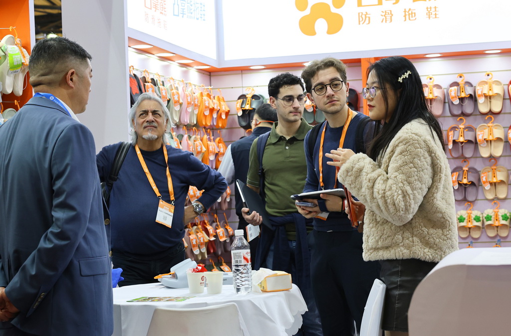 3月1日，展商工作人员（右一）向采购商介绍产品信息。