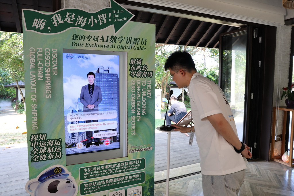 3月25日，工作人员在博鳌亚洲论坛年会会场与AI数字讲解员对话。新华社记者 王益亮 摄
