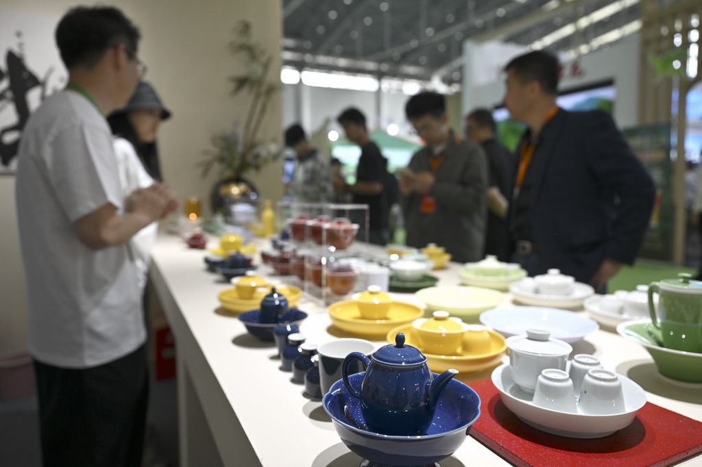 5月8日,参观者在第十八届安徽国际茶产业博览会上挑选茶具。